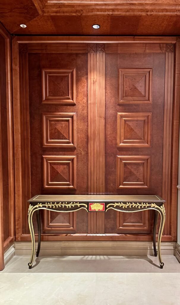 Hand carved console table with gilded leaf carving and red lacquered centre panel, made by Morbagh Designs for Bharat Mandapam, New Delhi