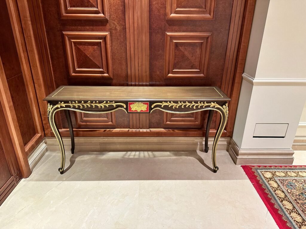 Carved walnut toned console table with gold detailing by Morbagh Designs